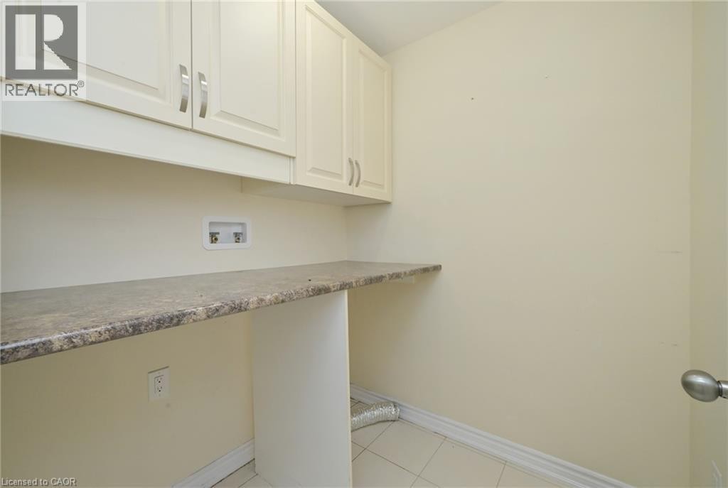 Built-in cabinetry with brushed nickel hardware, ample countertop space, and tile flooring - 64 Maple Cider Street, Caledon, ON