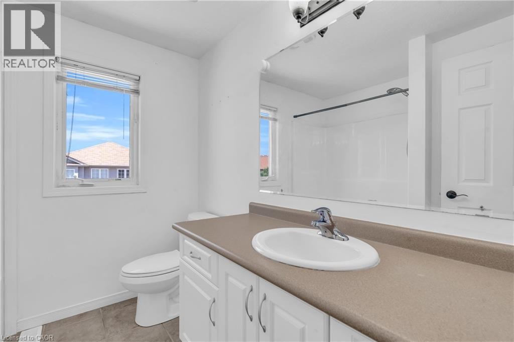 White vanity with cabinet storage, integrated sink, and laminate countertop - 50 Howe Drive Unit# 19B, Kitchener, ON