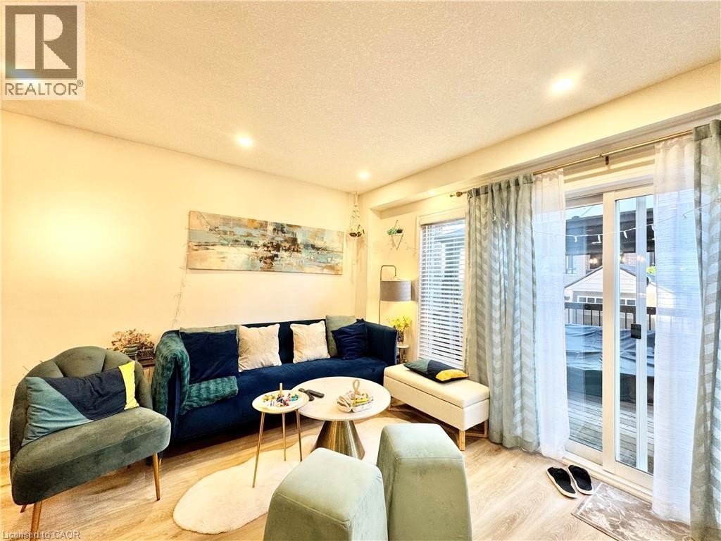 Recessed ceiling lighting, light wood-finish flooring, and a sliding glass door providing outdoor access - 1335 Countrystone Drive, Kitchener, ON