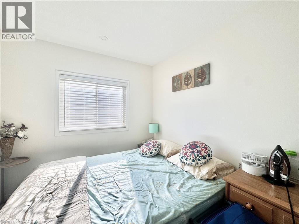 Window with horizontal blinds and white trim, recessed ceiling lighting, and light-toned wall paint. Come with the bed and side tables. - 1335 Countrystone Drive, Kitchener, ON