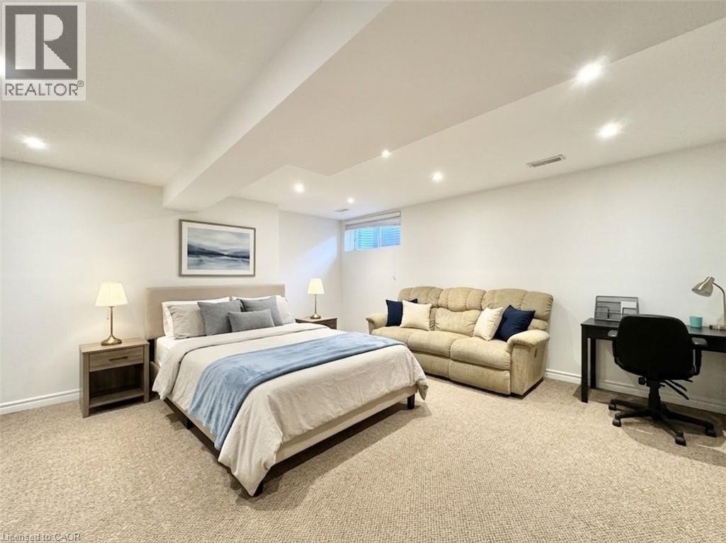 Staged with AI. Basement can be easily used as a bedroom. It comes with the half washroom as well. - 1335 Countrystone Drive, Kitchener, ON