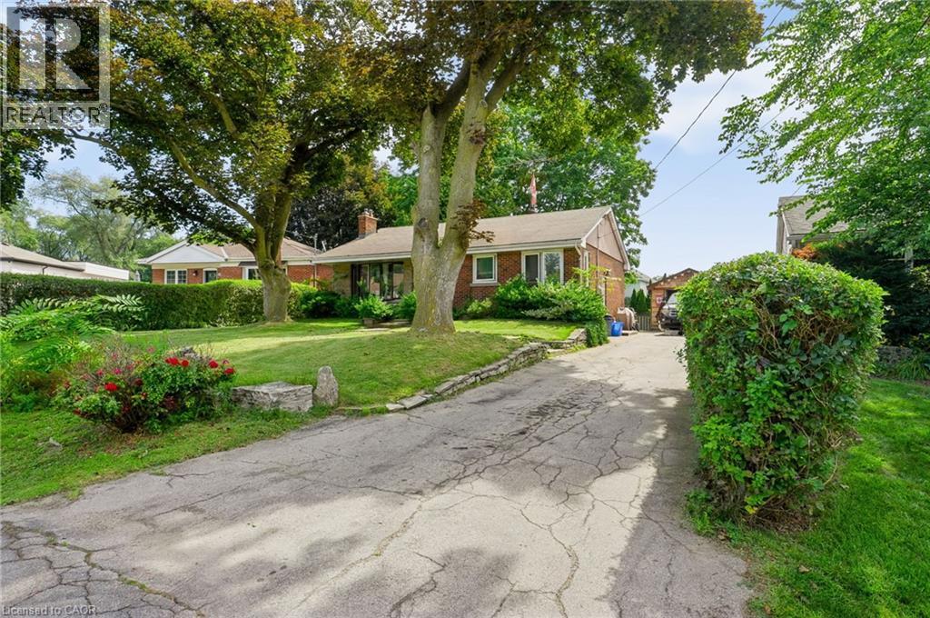 Brick exterior with a gabled roof - 1046 Shepherds Drive, Burlington, ON