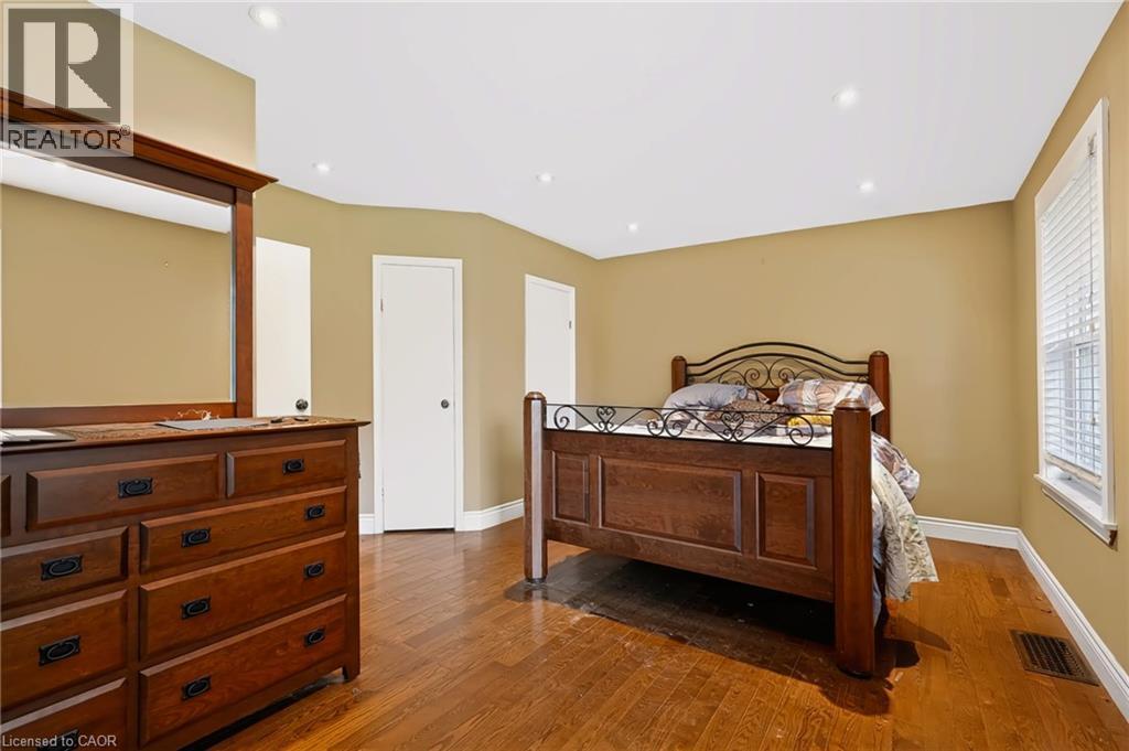 Recessed lighting, wood-finish flooring, and white trim - 1046 Shepherds Drive, Burlington, ON