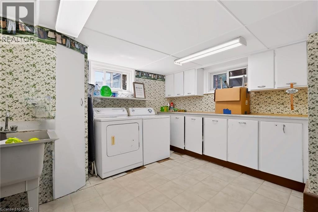 Built-in cabinetry, utility sink, overhead lighting, and window - 1046 Shepherds Drive, Burlington, ON