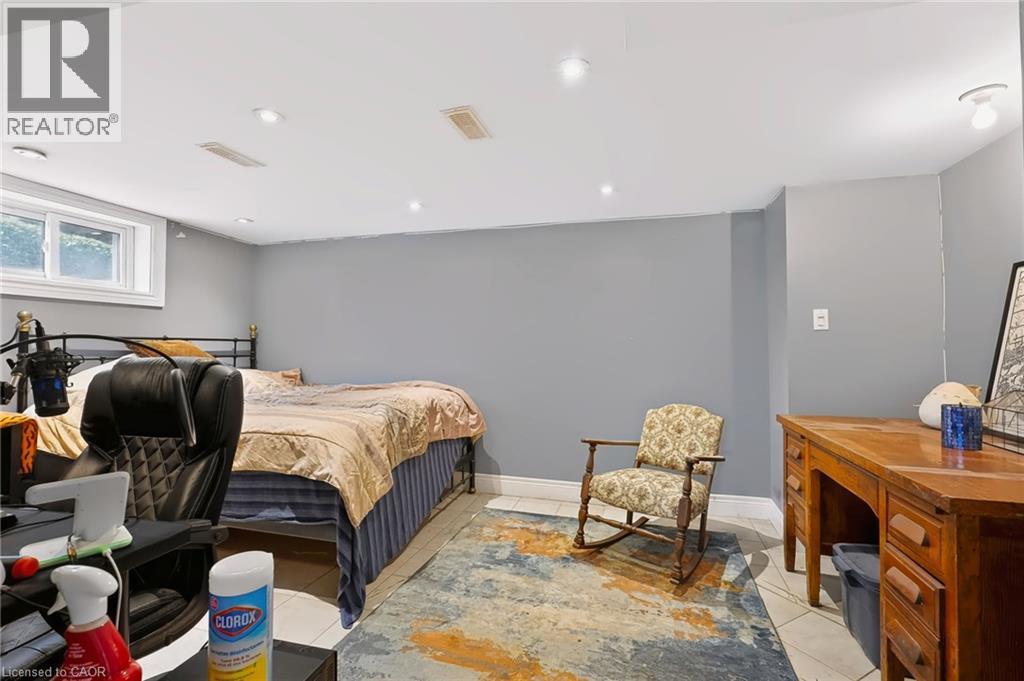 Recessed ceiling lighting, white ceiling, window with white trim, light gray walls, and light-toned tile flooring - 1046 Shepherds Drive, Burlington, ON