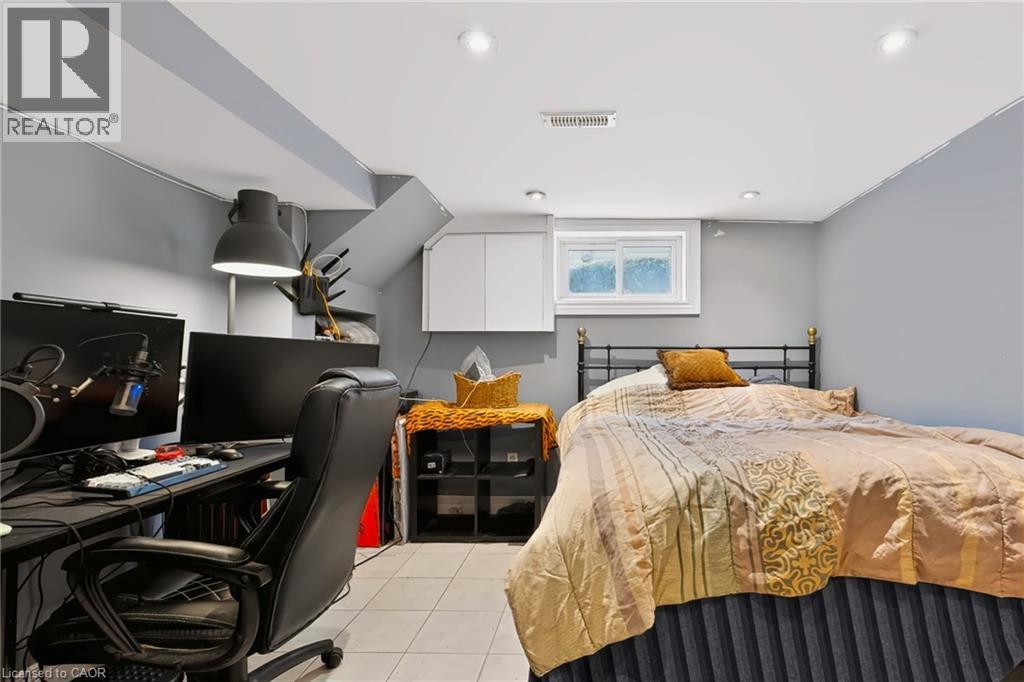 Recessed lighting, tile flooring, window with white trim, built-in shelving, and white overhead cabinetry - 1046 Shepherds Drive, Burlington, ON