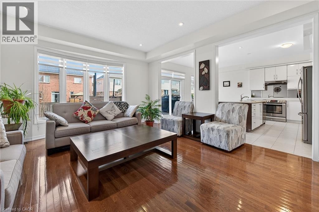 Living area featuring light wood finished floors and recessed lighting - 97 Sirente Drive, Hamilton, ON