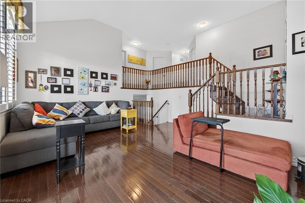 Living area with wood-type flooring and a high ceiling - 97 Sirente Drive, Hamilton, ON