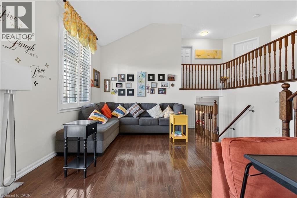 Living area featuring wood-type flooring and vaulted ceiling - 97 Sirente Drive, Hamilton, ON
