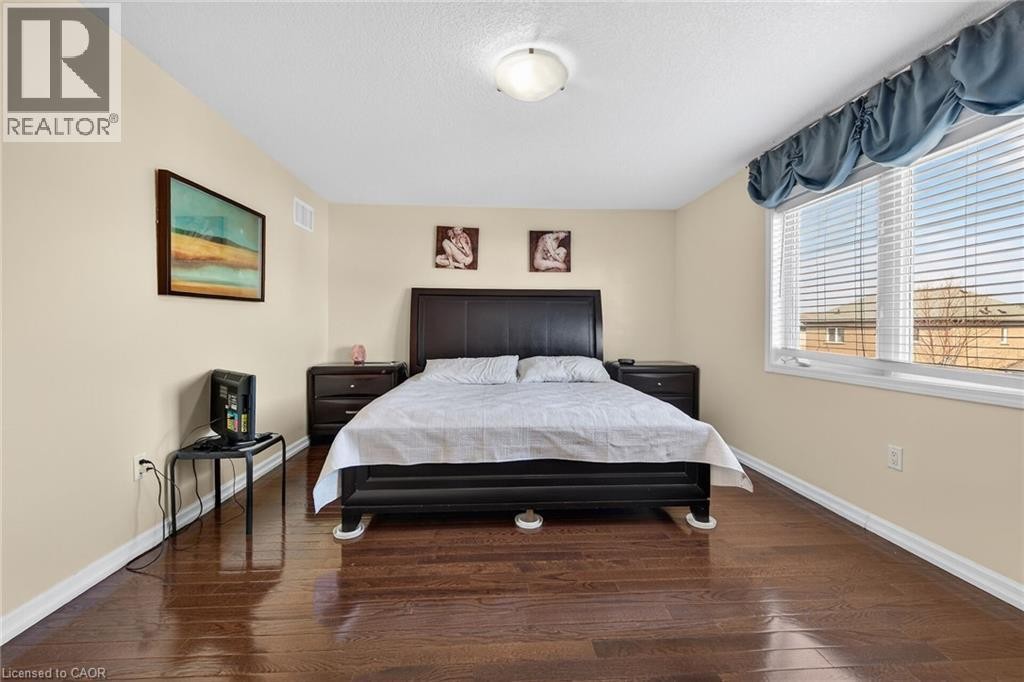 Bedroom with wood-type flooring and a textured ceiling - 97 Sirente Drive, Hamilton, ON