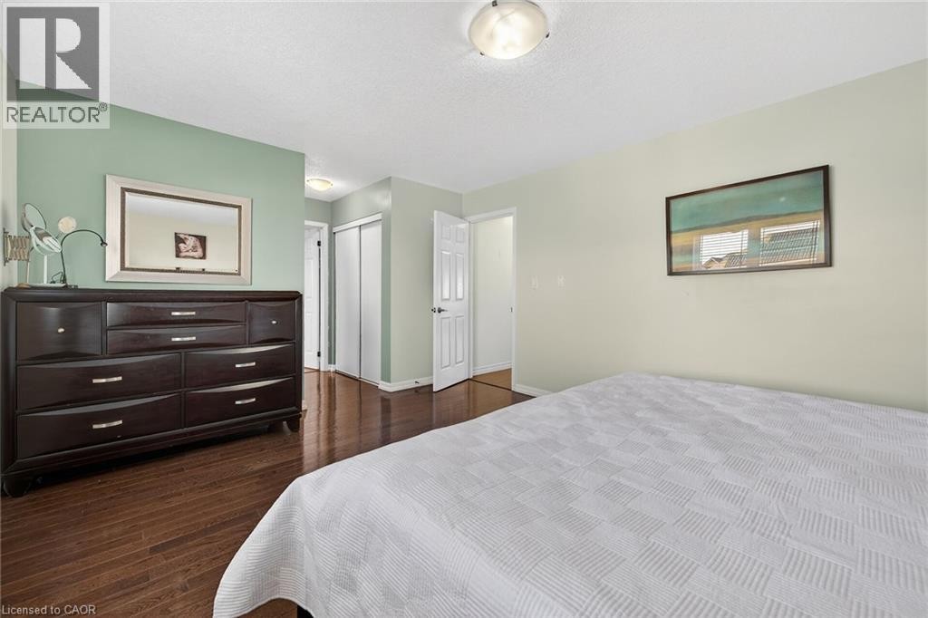 Bedroom featuring dark wood-style floors and a closet - 97 Sirente Drive, Hamilton, ON