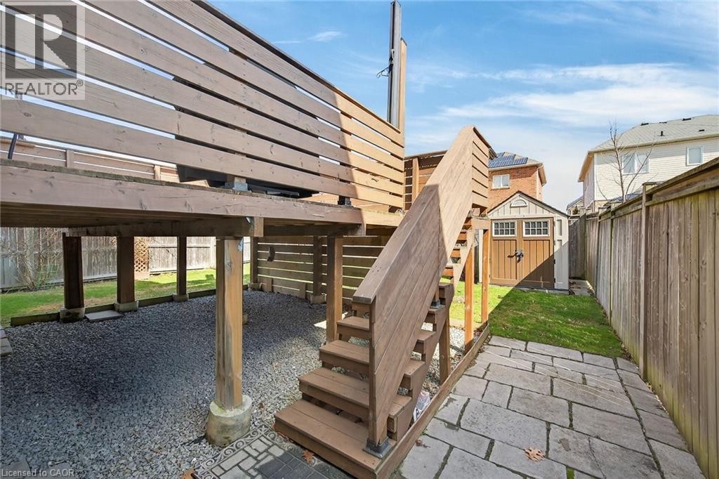 Fenced backyard with a storage shed and a patio - 97 Sirente Drive, Hamilton, ON
