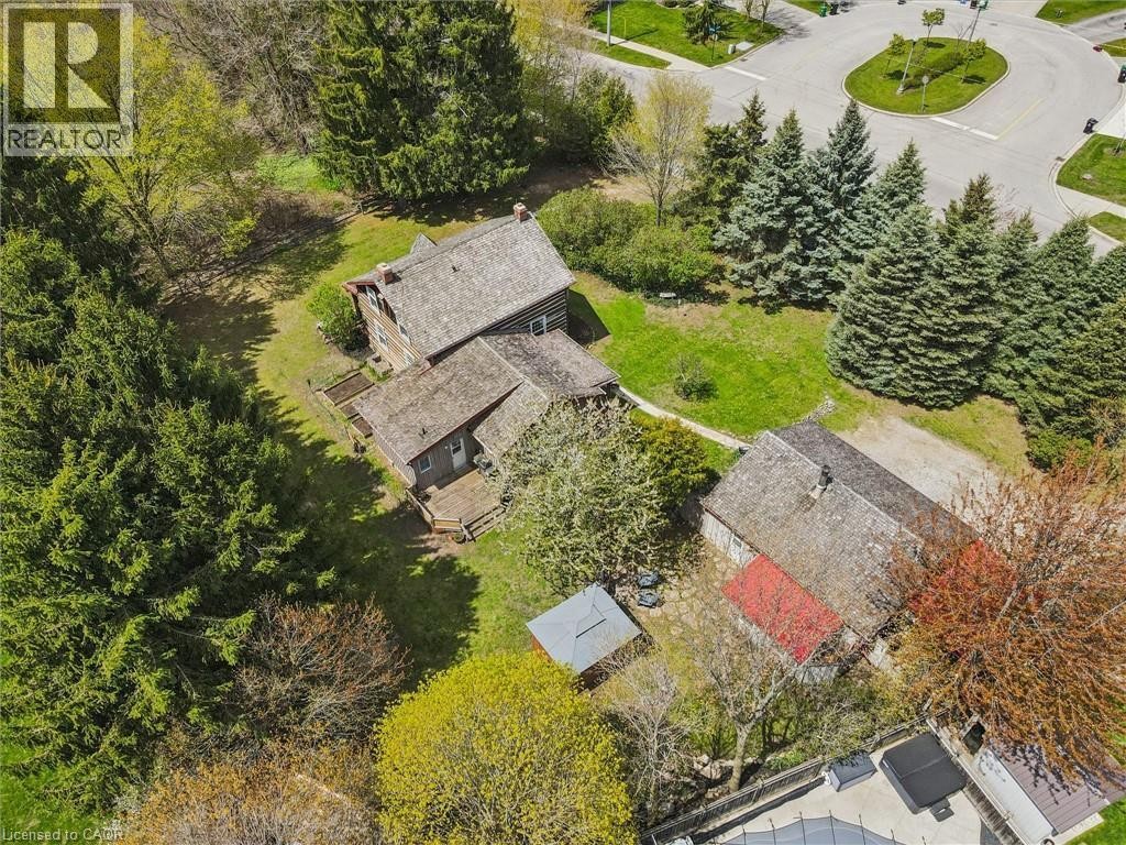 Wood-sided residence with multiple gabled roofs, expansive surrounding greenery, and a paved circular roadway - 630 Robert Ferrie Drive, Kitchener, ON