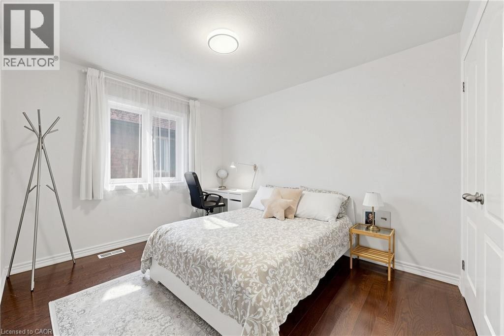White walls, dark wood-finish flooring, and white trim - 173 Raymond Road, Ancaster, ON