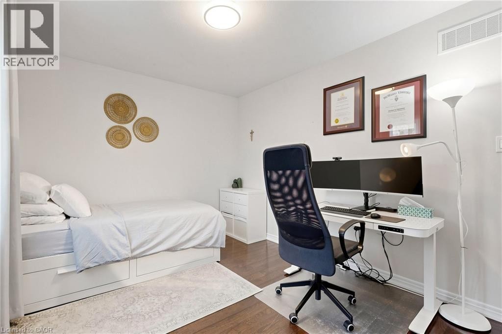 Hardwood flooring, crisp white walls, and a built-in bed frame with integrated storage drawers - 173 Raymond Road, Ancaster, ON