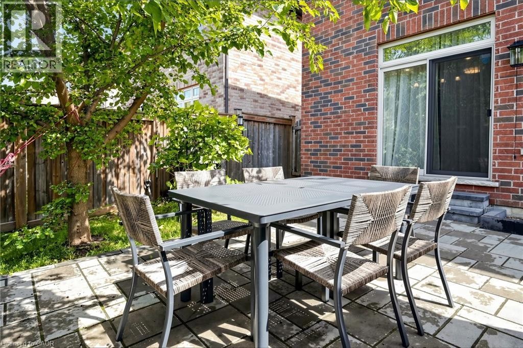 Brick exterior with a sliding glass door - 173 Raymond Road, Ancaster, ON