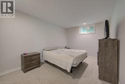 Carpeted room with light-colored walls and a recessed window - 