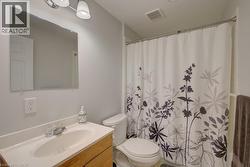Full bathroom featuring a vanity with a laminate countertop, undermount sink, and chrome faucet - 