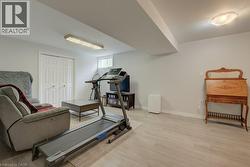 Spacious room featuring light wood-finish flooring, recessed lighting, and a window providing natural light - 