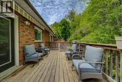 Expansive wood deck with a natural wood railing, offering outdoor living space - 