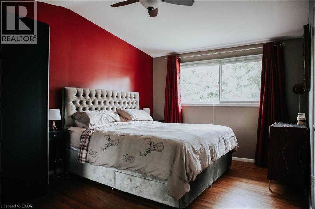 Wood-finish flooring with a ceiling fan and a window - 1 Vera Court, Hamilton, ON