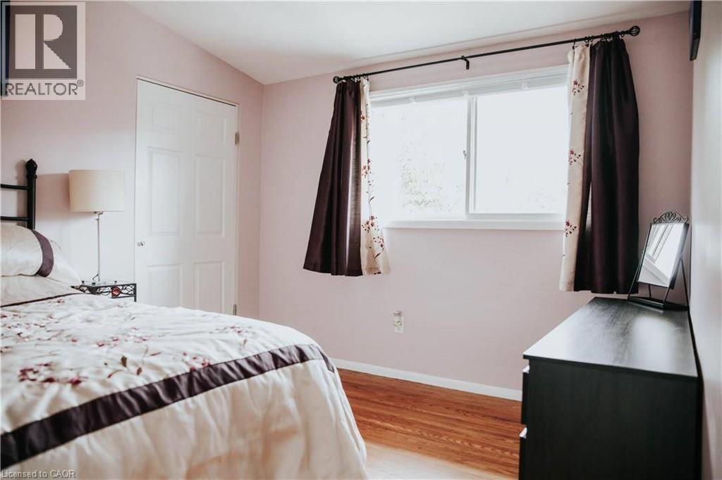 Hardwood flooring, painted walls, white trim, and a panel door - 1 Vera Court, Hamilton, ON