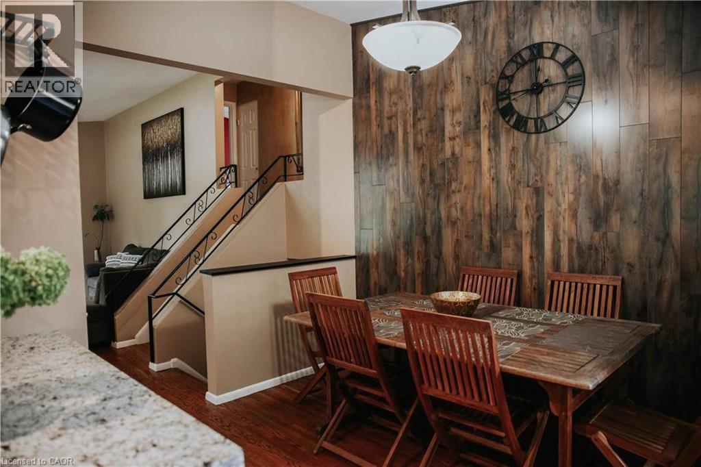Wood-finish accent wall with a flush-mount light fixture - 1 Vera Court, Hamilton, ON