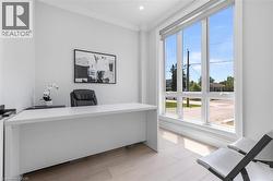 Bright room featuring expansive windows, light wood-finish flooring, white walls, and recessed lighting - 