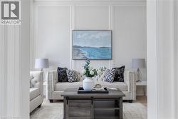 Living area featuring wainscoting accent walls and light-toned flooring - 