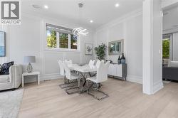 Dining area featuring light wood-finish flooring, recessed lighting, and a contemporary chandelier - 