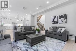 Open-concept living space featuring light wood-finish flooring and recessed lighting - 