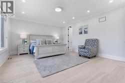 Hardwood-style flooring with a decorative accent wall and recessed lighting - 