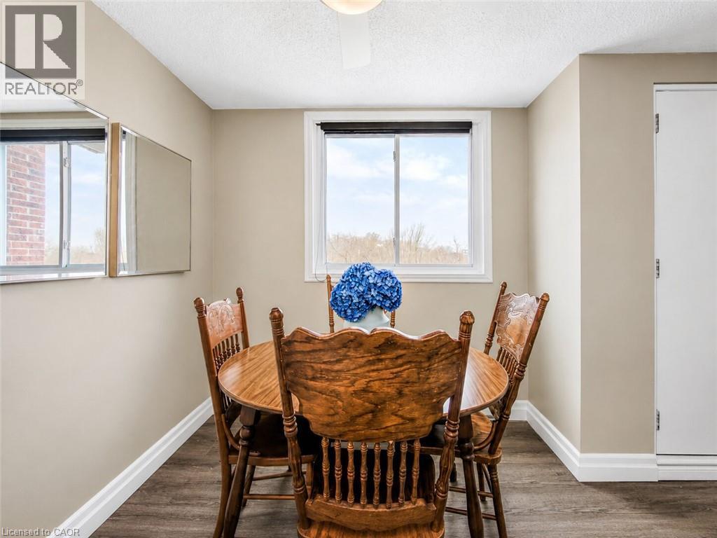 Interior space featuring wood-finish flooring, a white trim package, and light-toned wall paint - 4 Avalon Place Unit# 303, Kitchener, ON