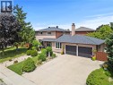 Brick exterior residence featuring an attached two-car garage, concrete driveway, and a shingled roof - 87 Monte Drive, Hamilton, ON 