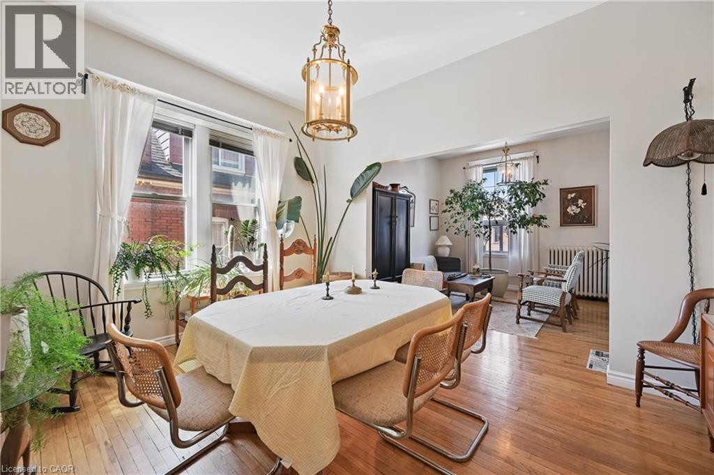Hardwood flooring throughout, with a recessed ceiling light fixture - 55 Barton Street W, Hamilton, ON