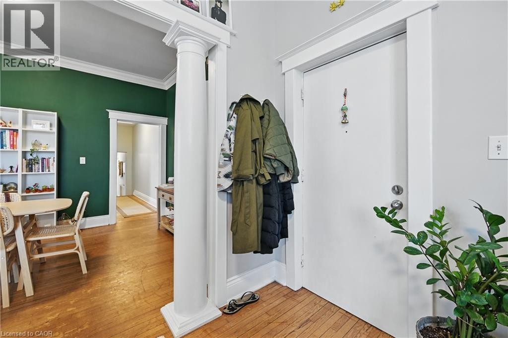 Hardwood flooring throughout, white trim and crown molding, and a decorative column - 55 Barton Street W, Hamilton, ON