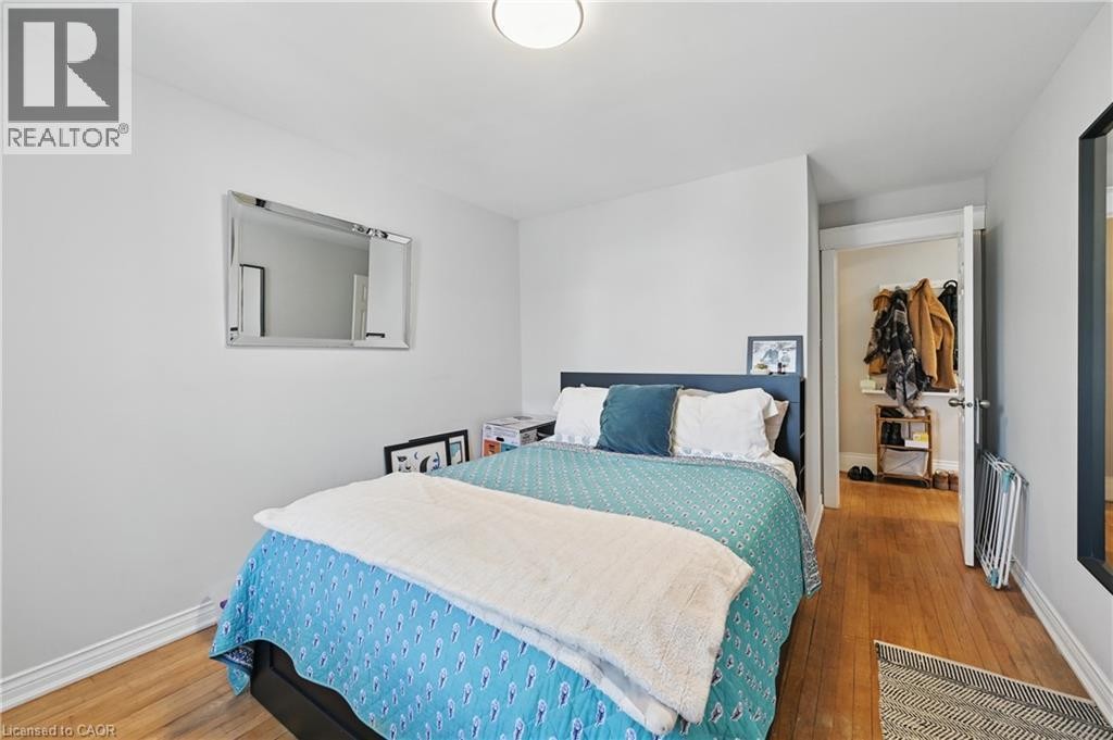 Hardwood-style flooring, neutral wall tones, and recessed lighting - 55 Barton Street W, Hamilton, ON