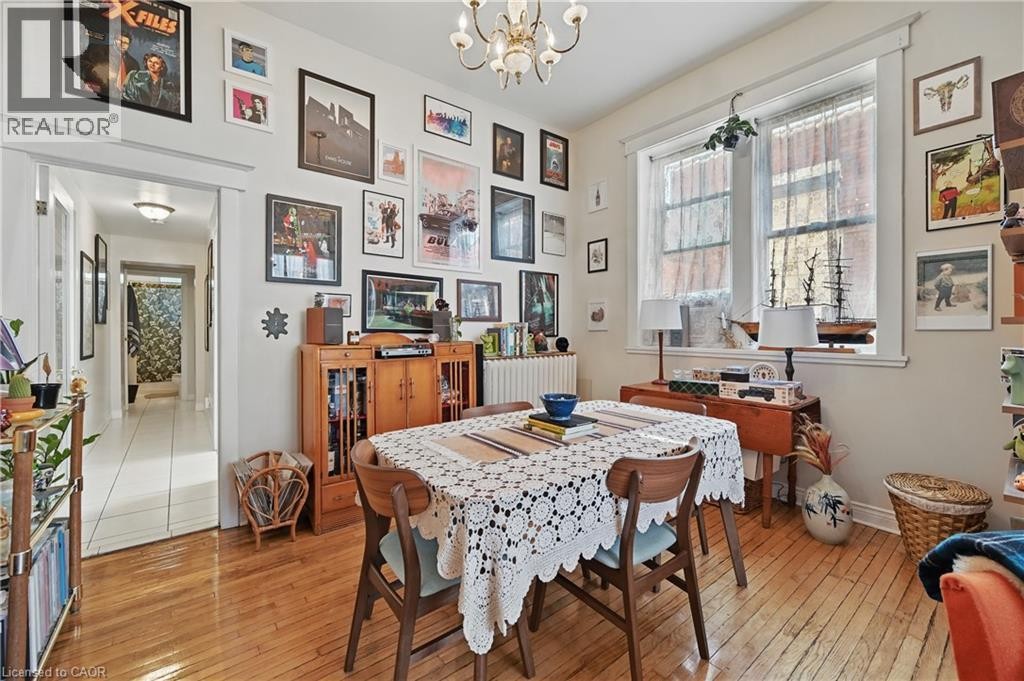 Hardwood flooring, recessed lighting, and a chandelier illuminate the dining space - 55 Barton Street W, Hamilton, ON