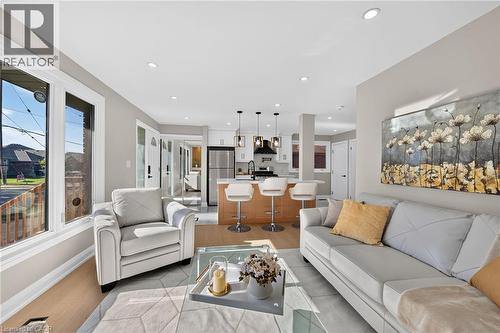 Open concept living area featuring recessed lighting, light wood-finish flooring, and multiple large windows - 135 Nugent Drive, Hamilton, ON 