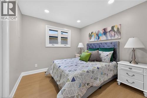 Recessed lighting, light-toned walls, wood-finish flooring, and a single window with white trim - 135 Nugent Drive, Hamilton, ON 