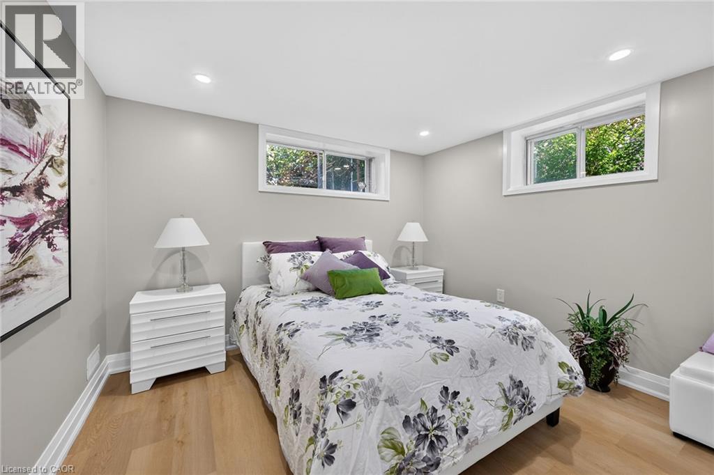 Recessed lighting, wood-finish flooring, two natural light windows, and light gray wall paint - 135 Nugent Drive, Hamilton, ON