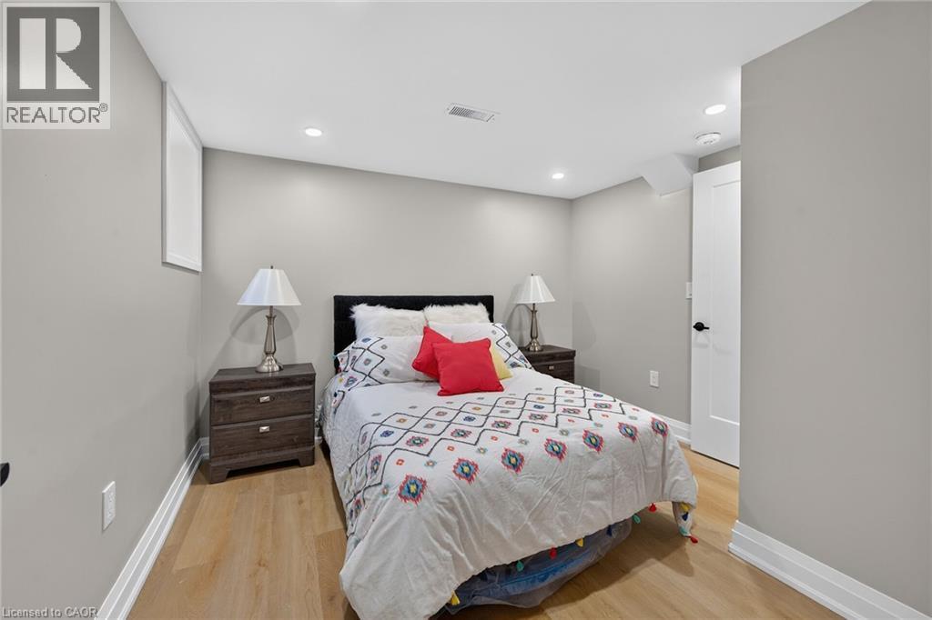 Recessed ceiling lighting, wood-finish flooring, white trim, and a built-in window - 135 Nugent Drive, Hamilton, ON