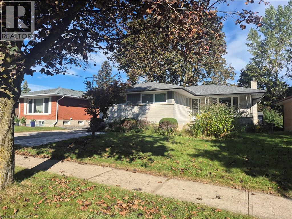 White brick exterior with a gray shingle roof - 11 Duncairn Avenue, Kitchener, ON