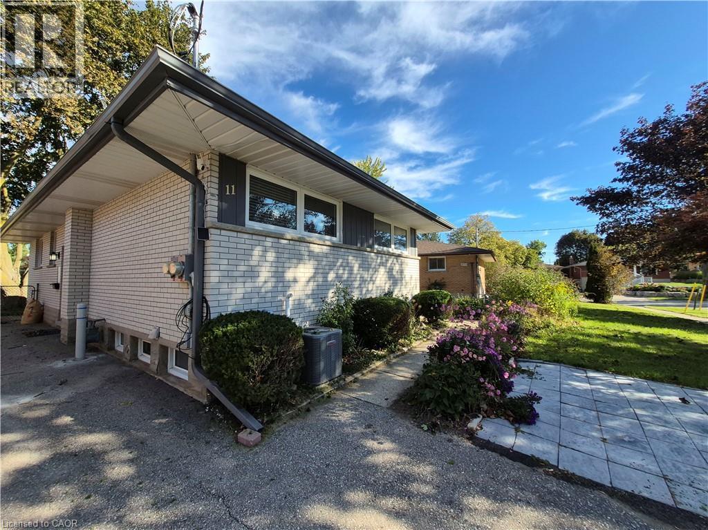Light-colored brick exterior with dark trim and gutters - 11 Duncairn Avenue, Kitchener, ON