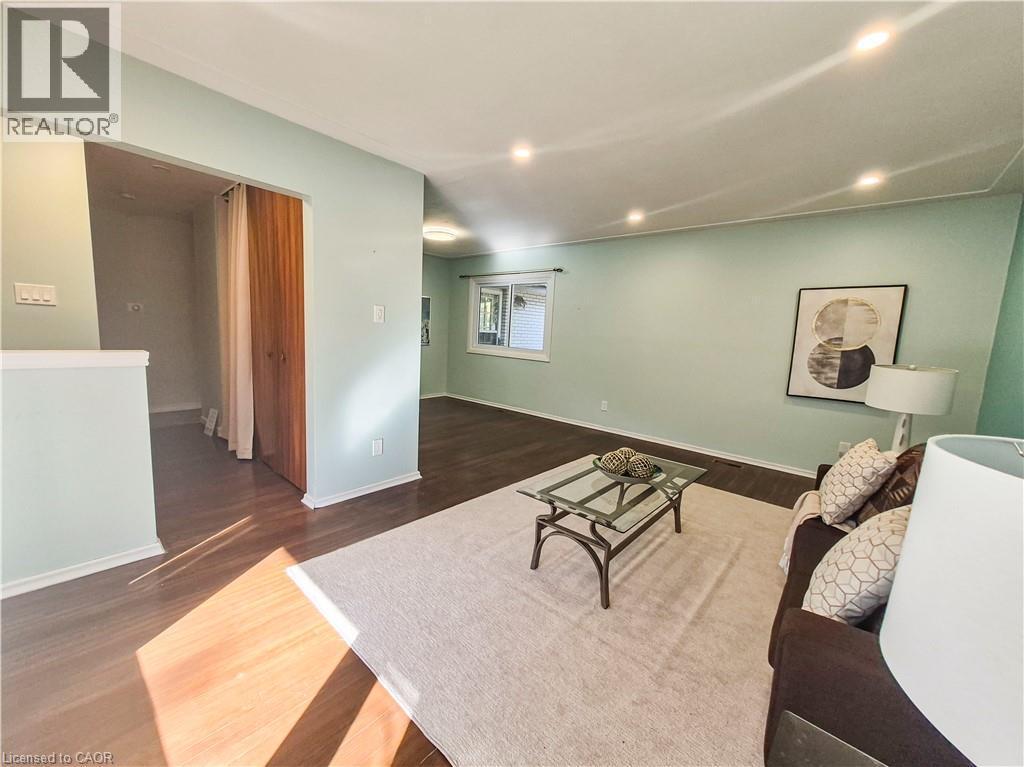 Recessed ceiling lighting, wood-finish flooring, light-toned wall paint, and a window with natural light - 11 Duncairn Avenue, Kitchener, ON