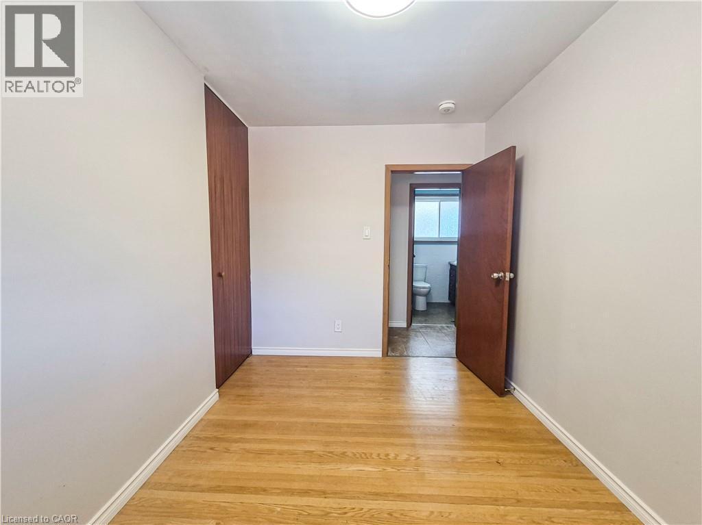 Wood-finish flooring with light-toned walls - 11 Duncairn Avenue, Kitchener, ON