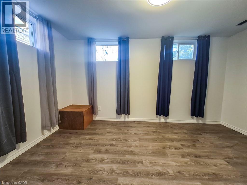 Recessed windows with natural light, wood-finish flooring, and white painted walls - 11 Duncairn Avenue, Kitchener, ON