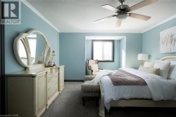 Recessed window, ceiling fan, crown molding, and carpeted flooring - 