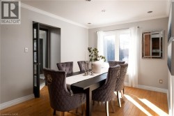 Hardwood flooring, crown molding, recessed lighting, and a large window with white trim - 