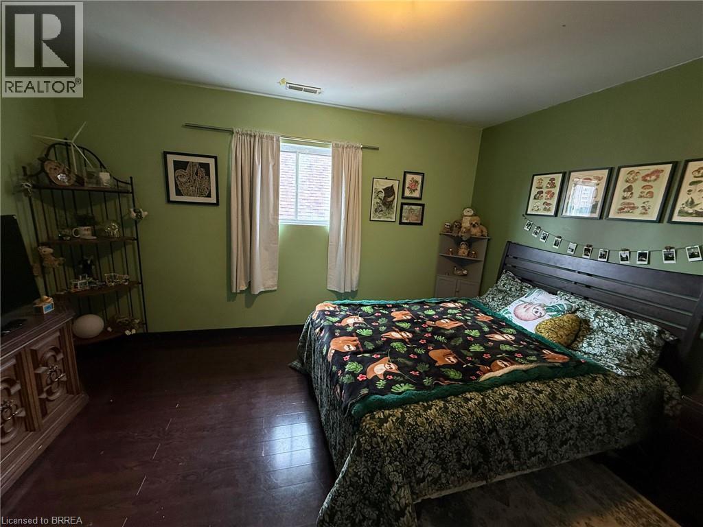 Wood-finish flooring with a window offering natural light - 12 Bridgeport Road E Unit# 18, Waterloo, ON